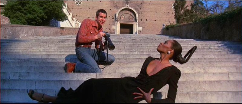 Anthony Perkins photographing Diana Ross on stone steps in a still from the 1975 Mahogany film trailer, five years after Ain't No Mountain High Enough