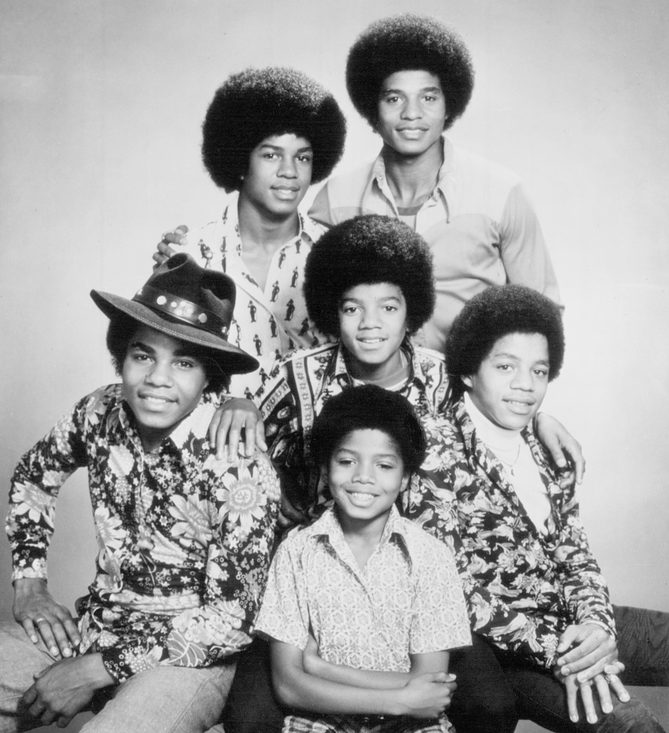 Black and white 1974 portrait of the six Jackson brothers, with Michael Jackson at the center, from the Dancing Machine era
