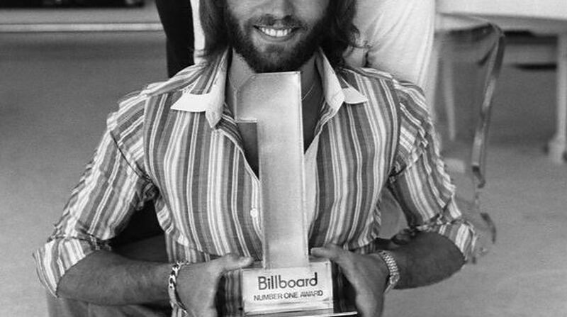 Maurice Gibb of the Bee Gees holding a Billboard Number One Award in 1977, at the height of 70s disco music